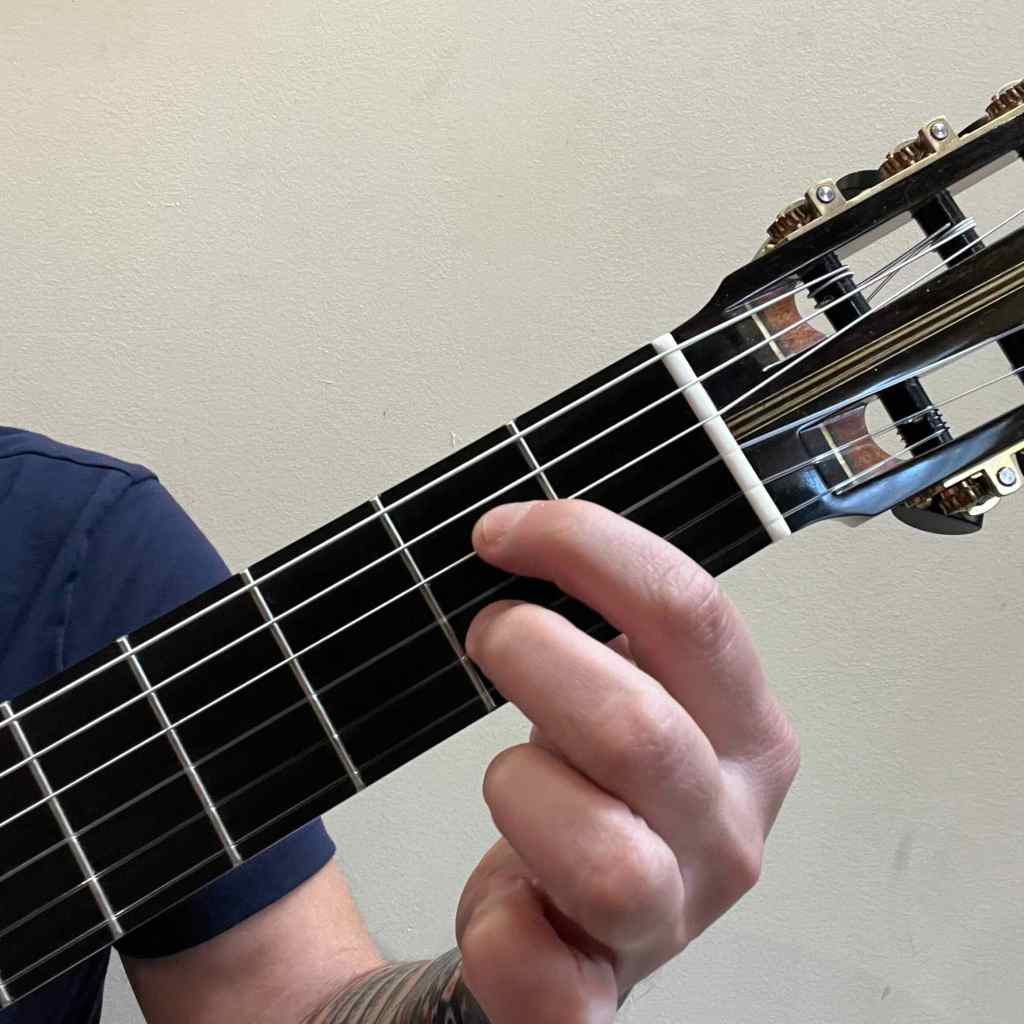 Jonathan Richter playing A7 guitar chord on a classical guitar