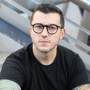 portrait of young rock player with glasses and a nose ring